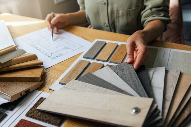 istock interior designer working on new house design project in office. choosing flooring and furniture materials and colors from samples 1585334643