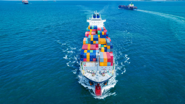 istock Aerial side view of smart cargo ship carrying container from customs container depot go to ocean concept freight shipping by ship service on blue sky .Freight Forwarding Service 1585338662
