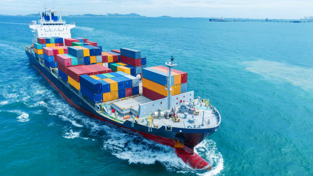 istock Aerial side view of smart cargo ship carrying container from customs container depot go to ocean concept freight shipping by ship service on blue sky .Freight Forwarding Service 1585339152