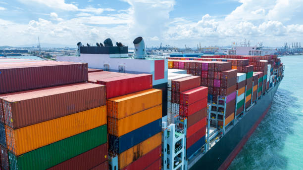istock Stern of large cargo container ship import export container box on the ocean sea on blue sky back ground concept transportation logistic and service to customer and supply change 1585339693