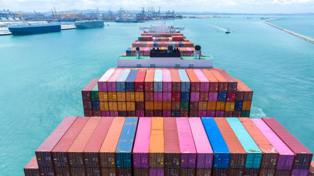 istock Stern of large cargo container ship import export container box on the ocean sea on blue sky back ground concept transportation logistic and service to customer and supply change 1585340235