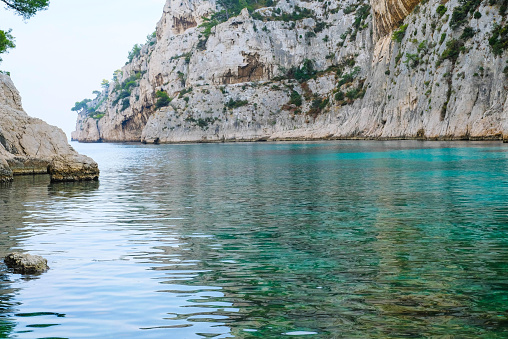 Beautiful beach with turquoise water and rocky cliffs in Calanques National Park, Cassis. Popular nature attraction in Southern France.