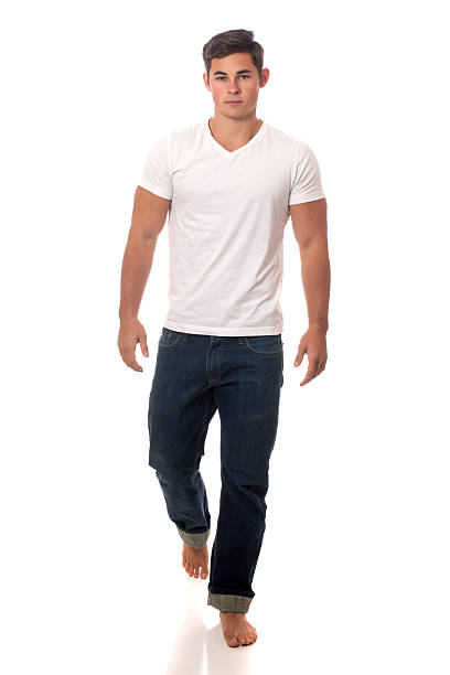 istock Young man walking in white T-shirt and jeans 158537852