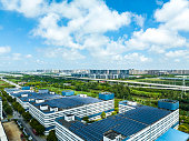Aerial view of solar panels installed on factory rooftop,Blue shiny solar photo voltaic panels system product.