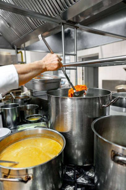 Chef cooking food at restaurant kitchen close up
