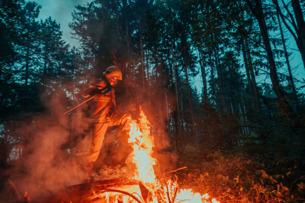 istock firefighter hero in action danger jumping over fire flame to rescue and save 1585392400