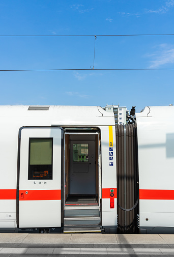Open door of passenger train against sky, Berlin central