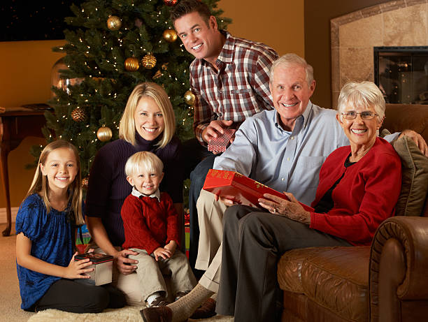 istock Multi Generation Family Opening Presents In Front Of Tree 158539818