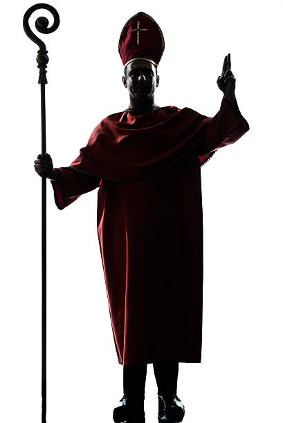 istock man cardinal bishop silhouette saluting blessing 158540718