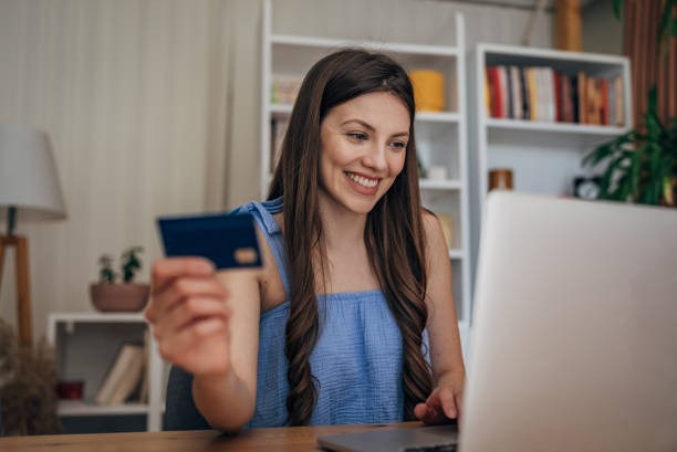 istock Woman shopping online on laptop 1585410663