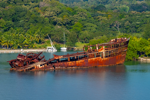 Stranded transport ship destroyed on the cliffs of a remote island after an accident