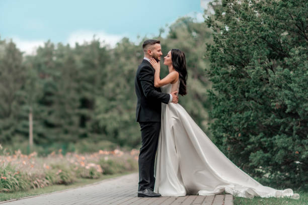 istock in full growth. bride and groom looking at each other tenderly 1585422260