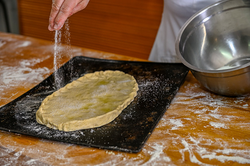 Baker kneading an oil cake
