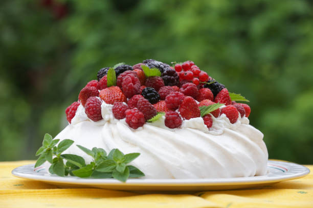 istock Pavlova cake - a meringue-based dessert with strawberries, blackberries, raspberries and mint leaves 1585428204