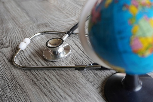 Selective focus image of stethoscope and world globe with copy space. Global health and world health day concept