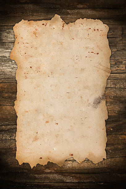 istock Damaged old paper on a wooden background 158544807