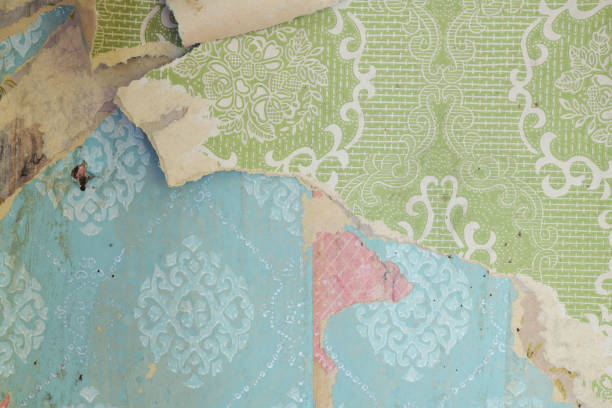 istock Old wallpaper on the wall. Old torn wallpaper for texture or background. 1585448245