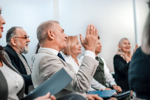 istock close up. a business man asks a question at a business meeting 1585480322