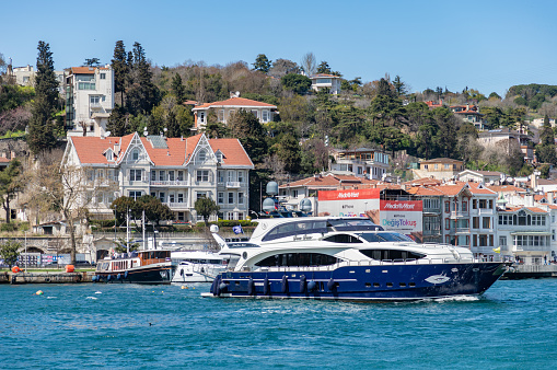 Istanbul, Turkey - April 8, 2023: A picture of a yacht on the Bosphorus strait.