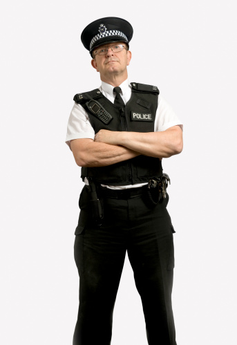 Isolated British Police officer with folded arms