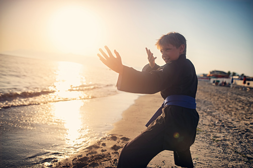 Funny fittle boy practicing kung fu on the beach.
Show with Nikon D850