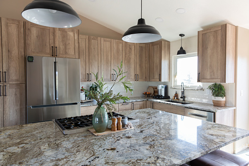 Modern kitchen with granite countertops and island.