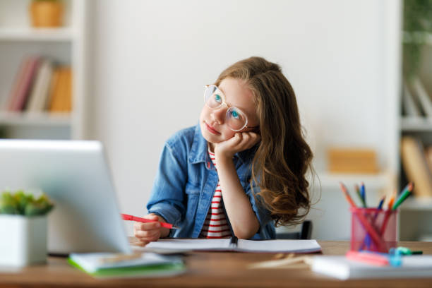 istock Girl doing homework or online education. 1585518345