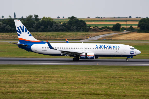 Sunexpress passenger plane at airport. Schedule flight travel. Aviation and aircraft. Air transport. Global international transportation. Fly and flying. Vienna, Austria - July 22, 2016: Sunexpress passenger plane at airport. Schedule flight travel. Aviation and aircraft. Air transport. Global international transportation. Fly and flying. sunexpress stock pictures, royalty-free photos & images