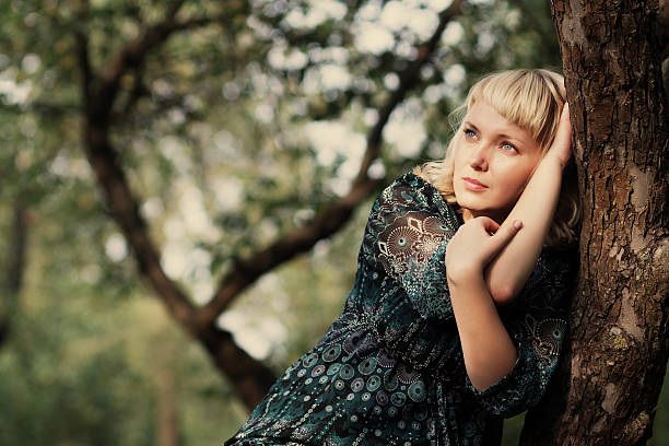 istock Sadness girl sitting on a tree branch 158552863