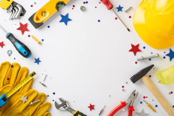istock Paying homage to laborers on Labor Day: Capture attention with this top-view image showcasing the American flag and building instruments on white background. Perfect for advertisements or text 1585530296