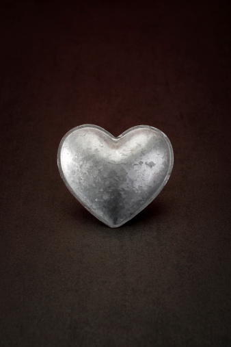 metal heart on stone background