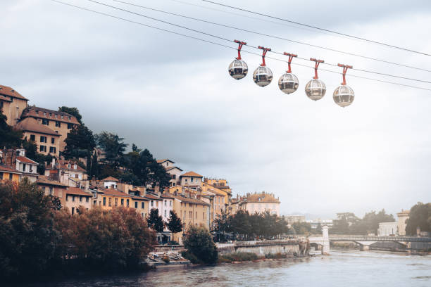 The quays of the Isere river in Grenoble french city with the Bastille cable car stock photo