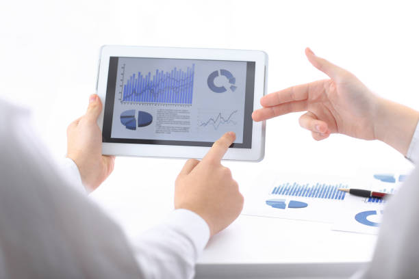 istock businessman pointing with pen on a digital tablet screen. 1585564318