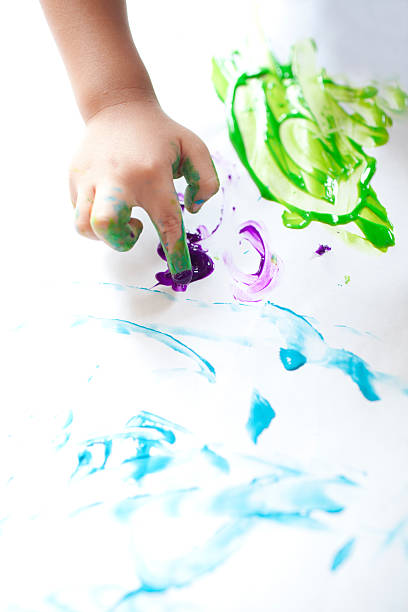 istock boy hand painting on the white paper 158556834
