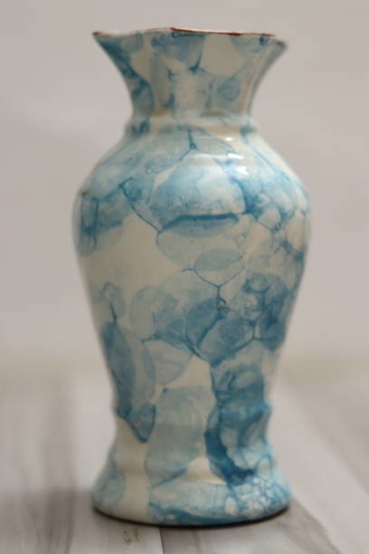 A Japanese styled white vase with blue coloured artistic patterns A Japanese styled white vase with blue coloured artistic patterns lota stock pictures, royalty-free photos & images