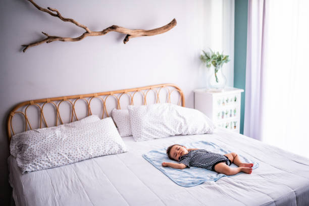 Baby boy sleeping on bed at the bedroom at home