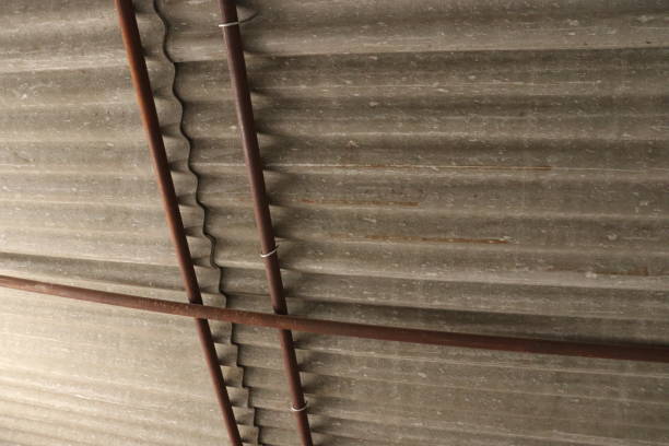 istock Cement Tin sheet Roof ceiling supported by three iron Rods 1585590780