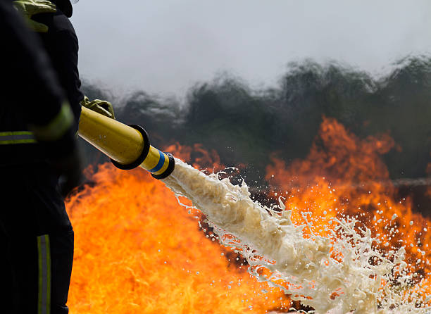 Firefighting foam. Fire-fighters applying foam to a fire. extinguishing photos stock pictures, royalty-free photos & images
