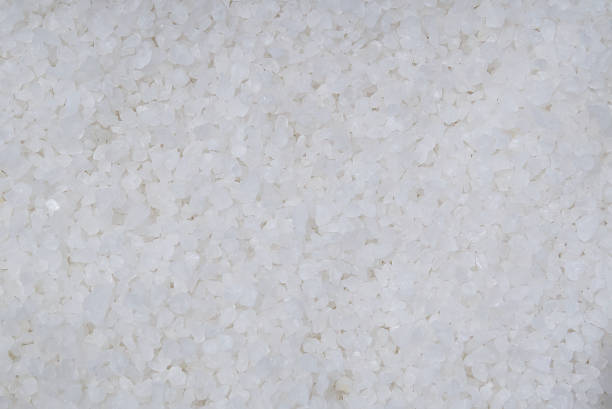 istock Coarse rock salt texture. Background from white sea salt. 1585595165