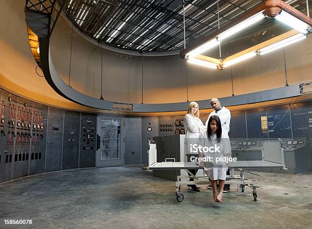 Psychiatric Patient And Nurses In Surreal Environment Stock Photo - Download Image Now
