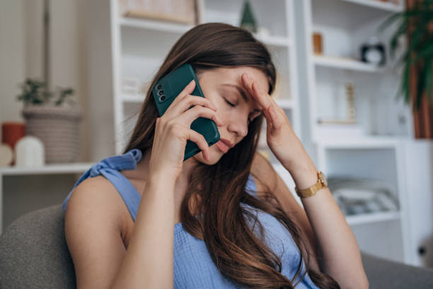 istock Worried woman talking on mobile 1585609390