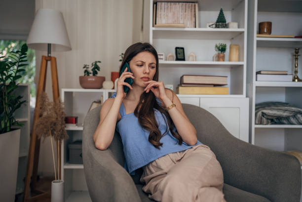 istock Worried woman talking on mobile 1585609916