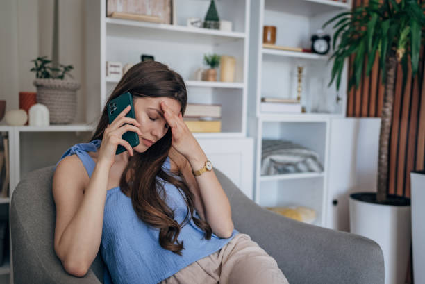 istock Worried woman talking on mobile 1585610909