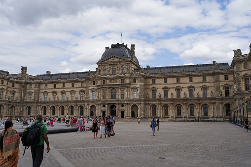 Paris, France - July 13, 2023 - a scenic view of the Louvre Museum at the heart of Paris in daylight. The Louvre or the Louvre Museum is a national art museum in Paris, France. A central landmark of the city, it is located on the Right Bank of the Seine in the city's 1st arrondissement (district or ward) and home to some of the most canonical works of Western art, including the Mona Lisa and the Venus de Milo.