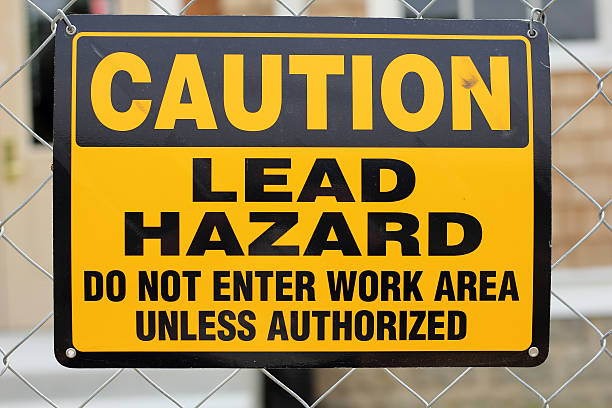 Lead Hazard Sign A caution sign warning of a lead hazard. Lead is a heavy metal and potentially hazardous to human health. graphite stock pictures, royalty-free photos & images