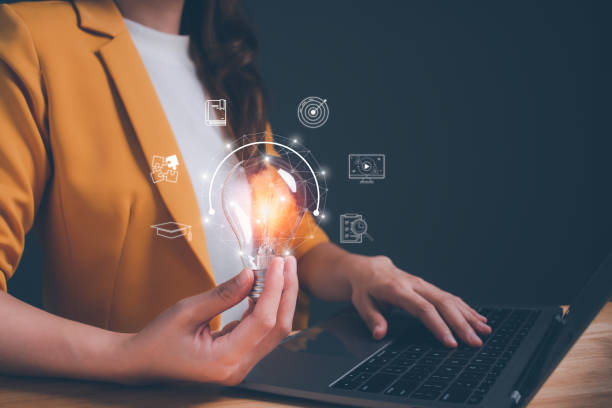 istock Businesswoman holding light blub with virtual Global Internet connection. Woman use computer to searching for information. Concept of inspiration creative smart thinking and innovation with network. 1585622431
