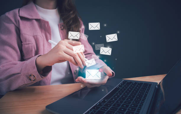 istock Businesswoman hand holding e-mail icon letter. Business e-mail communication and digital marketing. Inbox receiving electronic message alert. E-mail in virtual screen. New email notification concept. 1585622880