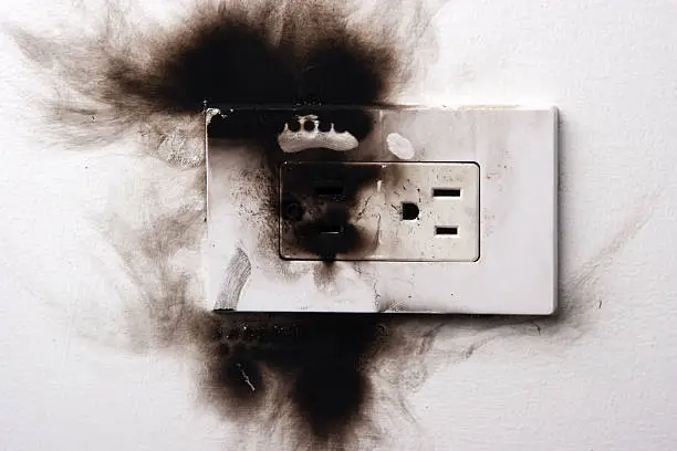 Photo of A dangerous situation shown with a burnt electronical socket