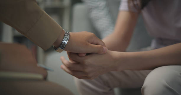 istock Young professional therapist touch hands of patient while talking and anxiety 1585630703