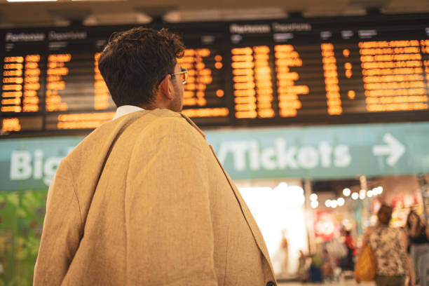istock Millennial Indian businessman commuting for work. He is taking a train from the station . 1585631236